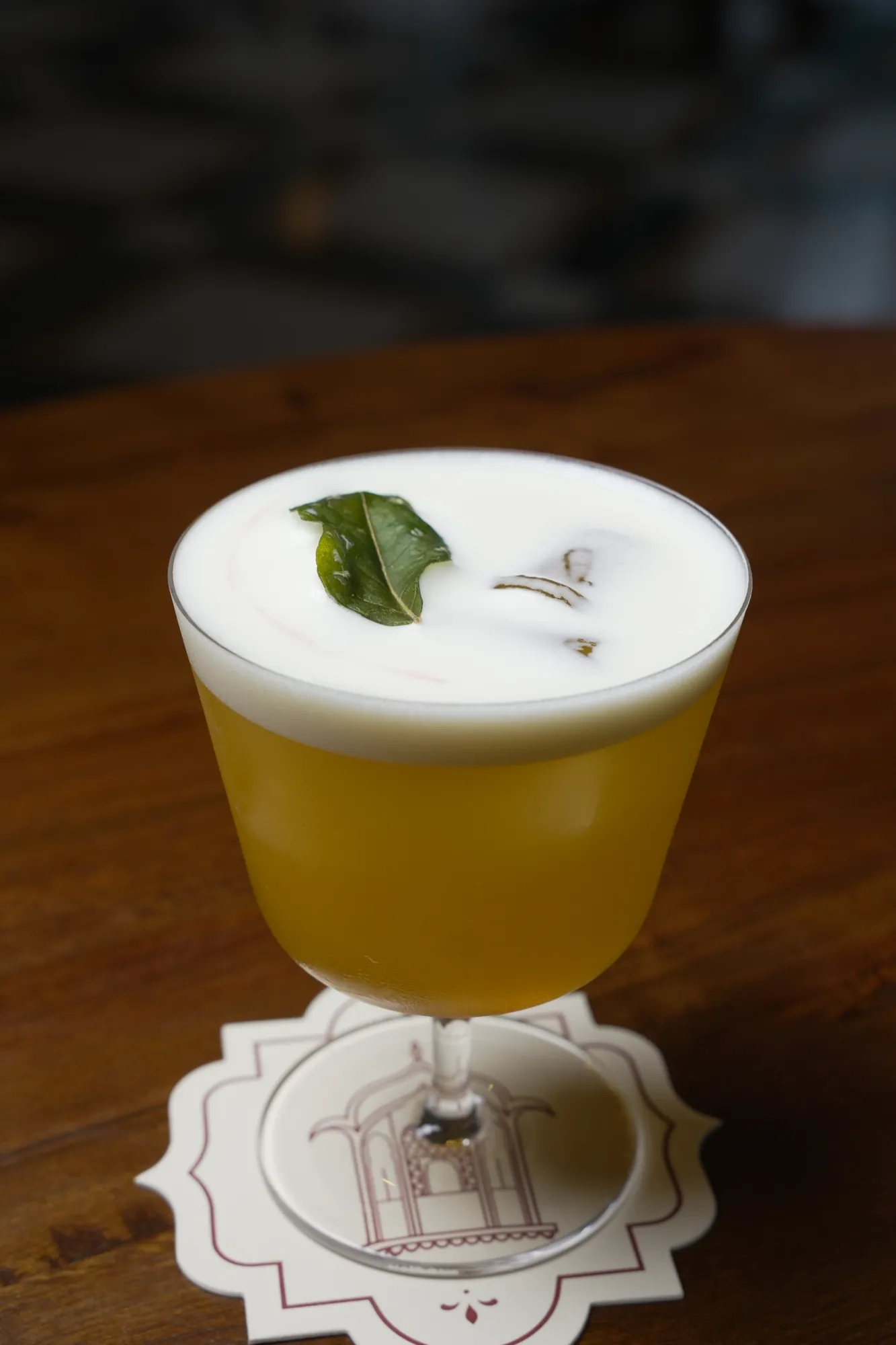 A golden signature cocktail on a Sawai coaster