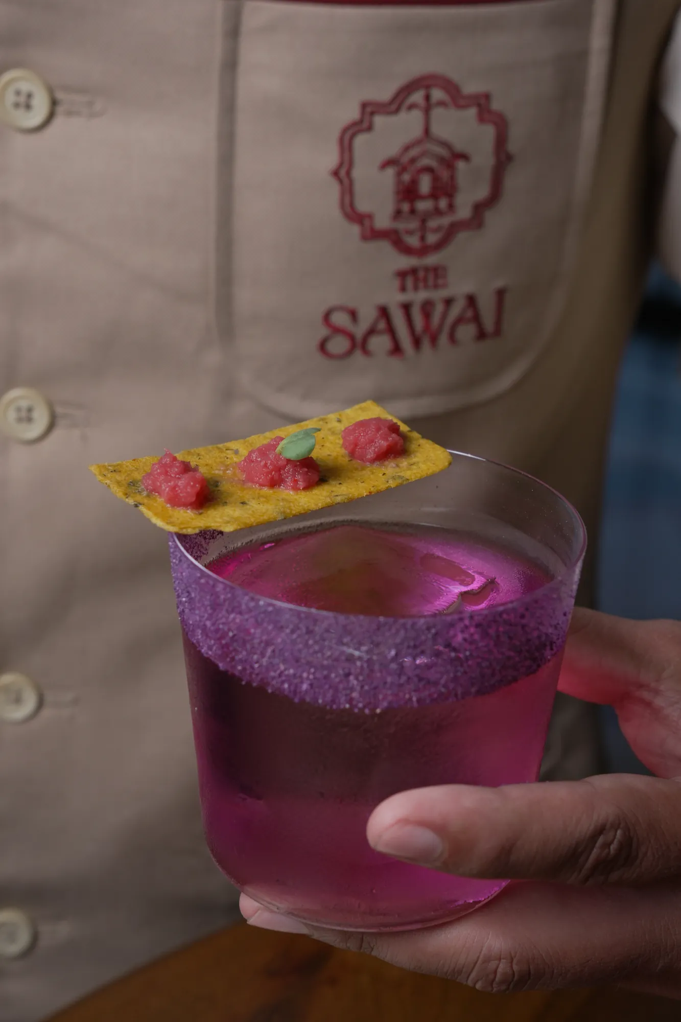 A violet cocktail, served