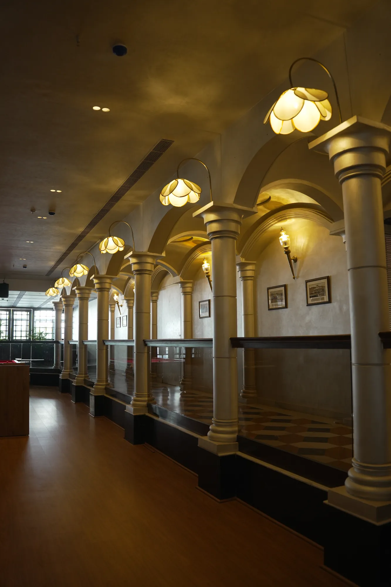 A colonnade of ivory columns and lotus lamps