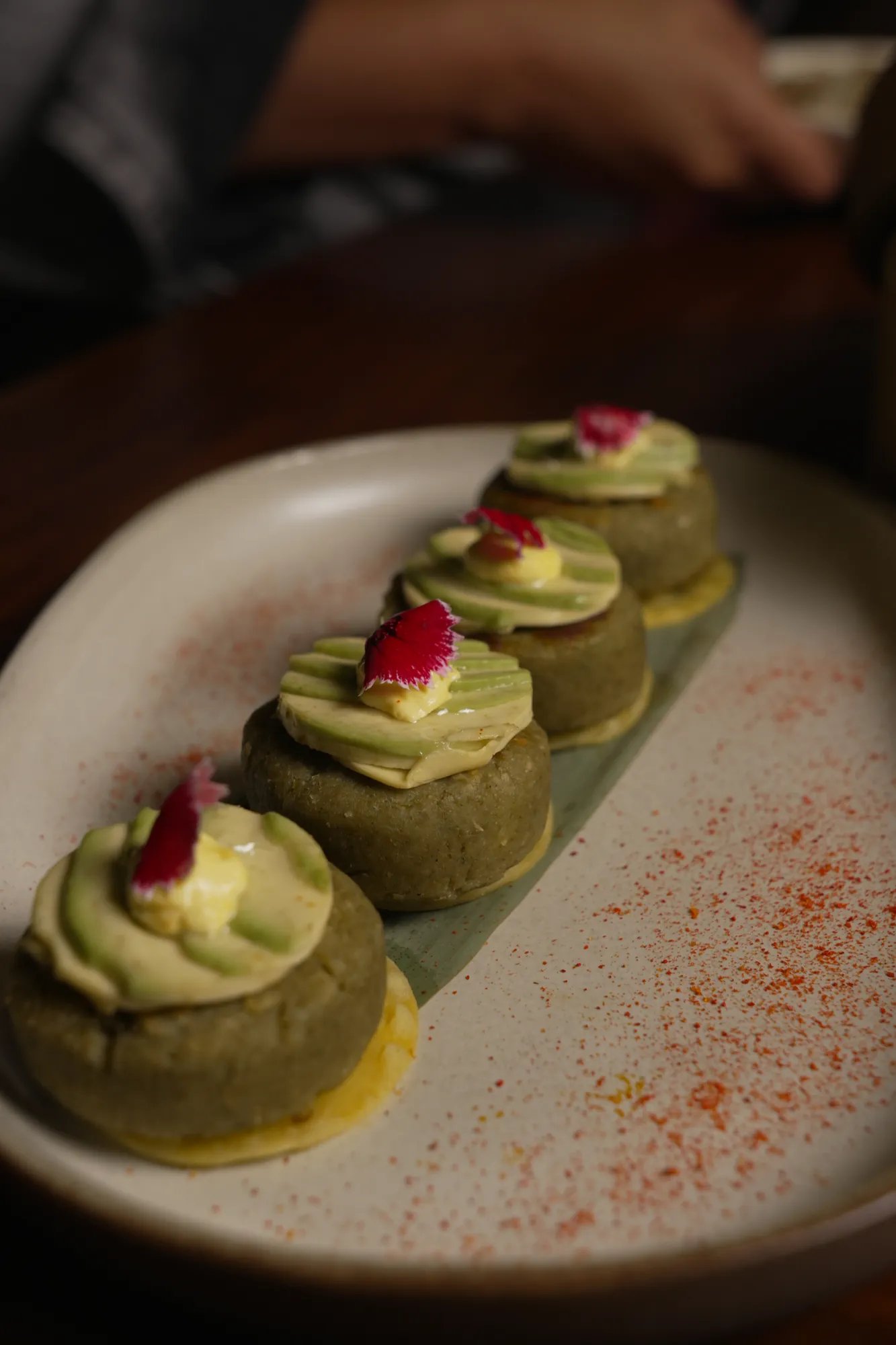 Kebabs crowned with avocado and rose