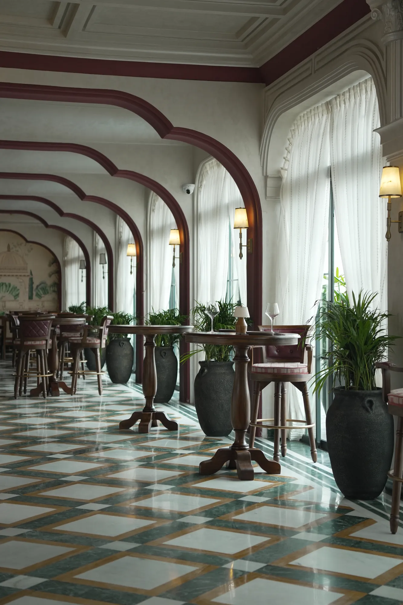 Palms and high tables along the arcade