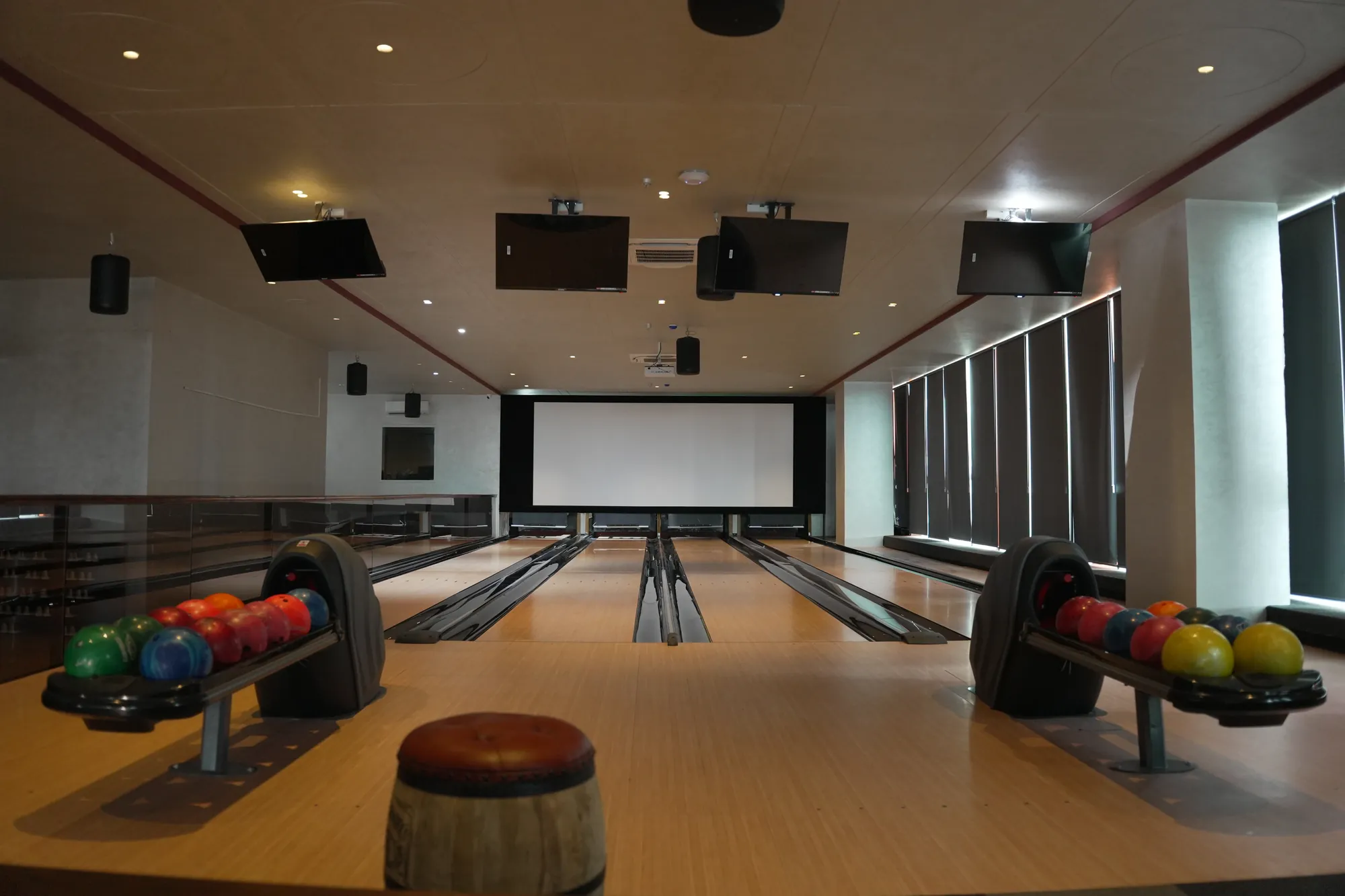 The bowling lanes and screening wall